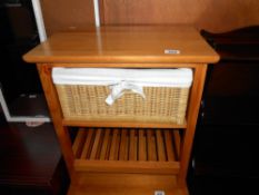 A pine bathroom unit with a wicker drawer, height 59cm, width 51cm approx.