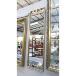 A tall framed mirror.