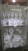 Approximately 25 cut glass wine and other drinking glasses.