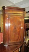 A Victorian mahogany corner cupboard.