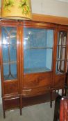 A good quality Edwardian mahogany display cabinet with domed middle door and astragal glazed side