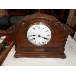 A 1930's oak 8 day mantle clock with enamel dial