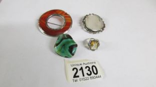 A banded agate early 20th century Scottish brooch together with a further stone set brooch,