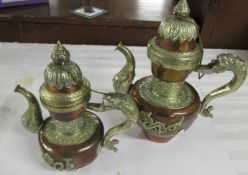 Two copper and white metal Tibetan teapots, 20th century, 28 and 23 cm tall.