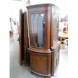 A dark stained astragal glazed corner cabinet,