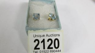 A pair of blue topaz stud earring sin 9ct gold (vibrant blue colour).