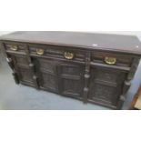 A carved dark wood stained sideboard.