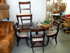 A darkwood stained oval dining table and 4 chairs