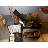 A box of assorted brassware, including boxed set of fish knives and forks, trivet, old tin,