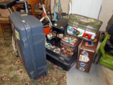 A collection of labelled well travelled suitcases and hand luggage