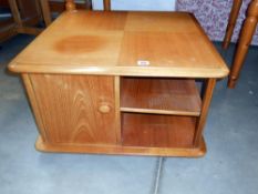 An oak effect coffee table with cupboards and shelves 76cm x 76cm x height 47cm
