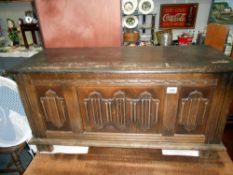 A 1950's oak linen/blanket box with linen fold front 93cm x 40cm x height 47cm