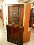 A wide oak corner cupboard with leaded glass door, width 90cm, depth 55cm,
