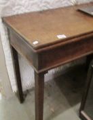 A mahogany fold over card table with square inverted legs.
