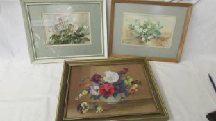 2 framed and glazed floral watercolours and an oil painting of a bowl of pansies.