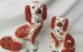 A Staffordshire spaniel, 30 cm and a smaller example, 23 cm.