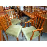 A set of 6 dining chairs with green fabric seats