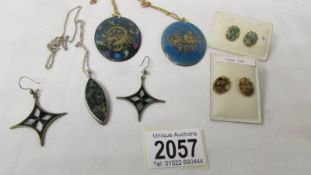 A silver pendant, a pair of silver earrings, a pair of jade earrings,