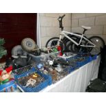 A large quantity of used bicycle parts including gears, levers, lights, seats,