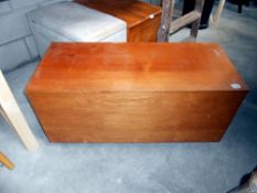 A teak blanket box on castors 100 x 43 x 46 cm