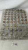 23 sleeves of assorted foreign coins, in excess of 1000 coins in total.