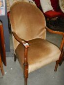An oak framed Edwardian arm chair.
