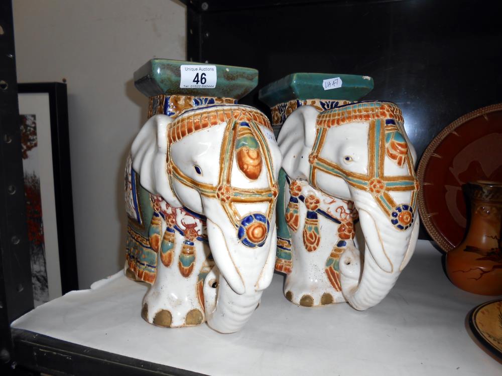A pair of pottery elephant plant stands,