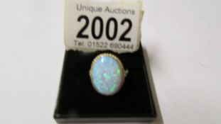 A large 9ct gold reconstituted opal ring, size M half, approximate total weight 3.7 grams.