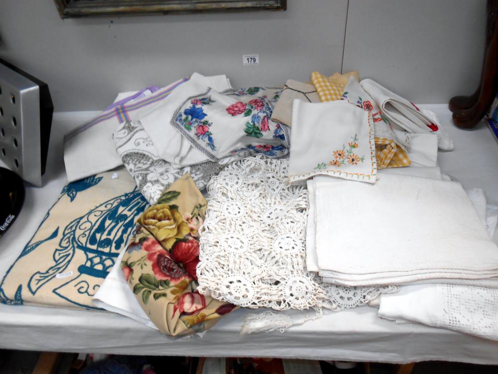 A box of household textiles including embroidered linens,