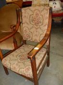 An Edwardian oak framed arm chair.
