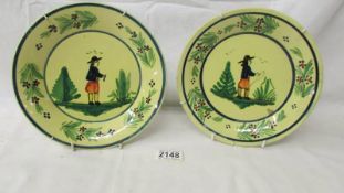 A pair of 19th century hand painted Breton Quimper plates, 21 cm.