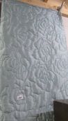 A pale blue lightweight bed throw/quilt, 225 x 280 cm.