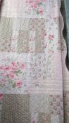 A floral lightweight throw/quilt with scallop edge detail, 260 x 240 cm.