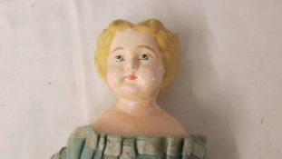 A 19th century papier mache' doll, in good condition for age, 35 cm.