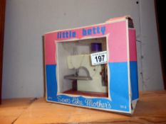 A vintage boxed Little Betty sewing machine