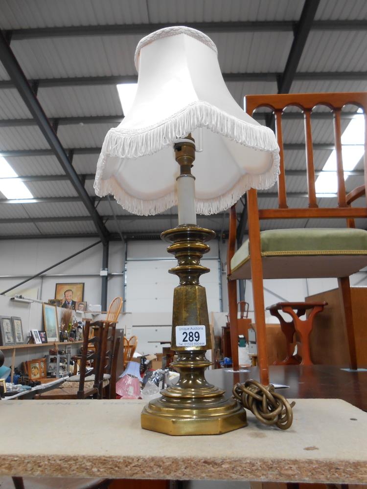 A vintage spelter table lamp with an antique brass finish,