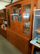 A large teak effect wall unit with glazed doors and drawer base Height 190cm,
