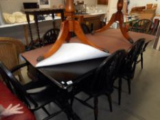 A dark oak table and 6 wheel back chairs height 75cm top 182cm x 83cm