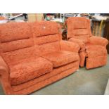 A salmon 2 seat settee and recliner