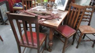An oak draw leaf table and 4 chairs.