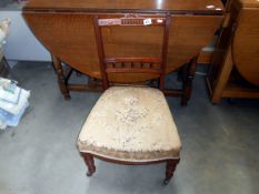 An Edwardian nursing chair with floral tapestry seat