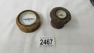 A boxwood compass circa 1890 (missing lid) and a carved wooden compass.