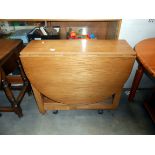 An oak drop leaf kitchen table with cupboard in centre height 75cm, open 136cm x 86cm,