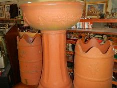 A terracotta coloured garden urn and 2 chimney pots (plastic).