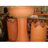 A terracotta coloured garden urn and 2 chimney pots (plastic).