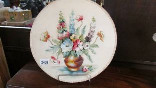 A large 1950's floral wall plaque signed D Ingham, 40 cm diameter.