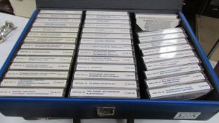 A case of cassette tapes & 1 empty case