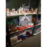 3 shelves of Christmas decorations including nativity figures and vintage items