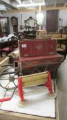 A very old and very distressed child's barrel organ and a child's mangle.