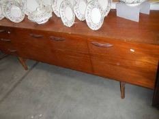 A retro teak sideboard with 3 drawers including cutlery drawer (some scratches to top).